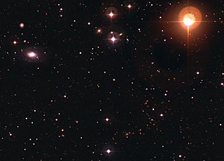 Galaxy ESO 570-19 and Variable Star UW Crateris