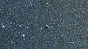 Infrared/visible-light crossfade view of the star cluster NGC 6520 and the dark cloud Barnard 86