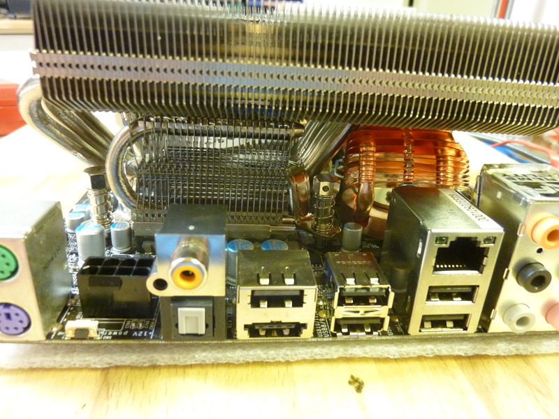 The bent and filed Thermaltake Extreme Spirit II fitted underneath the CPU cooler. The filing visible on the right side of the ES-II was an experiment and is not necessary for the current mounting