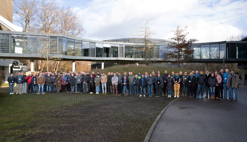 A group of people standing in front of a building

Description automatically generated