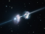 Artist’s impression of a gamma-ray burst shining through two young galaxies in the early Universe