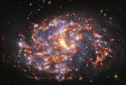 NGC 1087 vue par le VLT et l'ALMA dans plusieurs longueurs d'onde de lumière