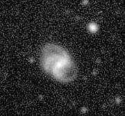 Disturbed spiral galaxy in the Abell 496 field