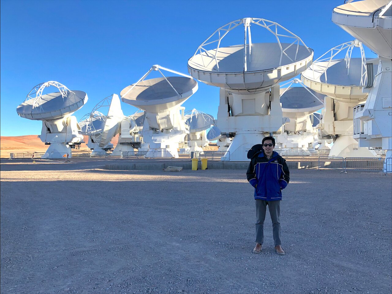 Daniel Tafoya next to the ALMA antennas in the Atacama Desert