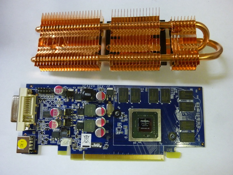 The Sparkle SXT2401024S3L-NMP with VGA connector and bracket removed and the cooler unmounted. Parts of the cooler has been ground off to make space for the end points of the CPU heat pipes.